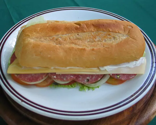 baguette with salami, ham, or tuna together with cheese, tomato, onion, and salad